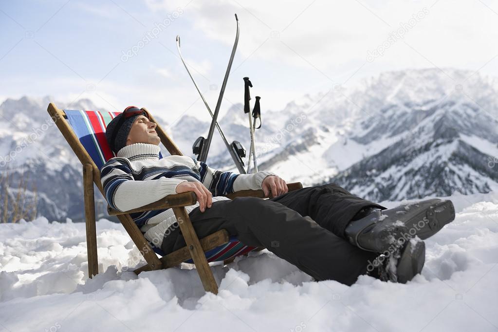 Skier resting on deckchair