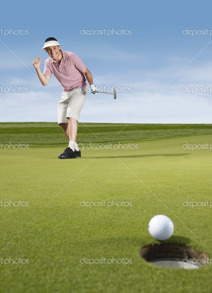 Male Golfer cheering after putting