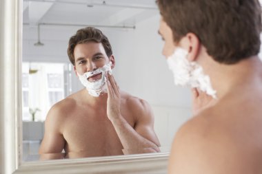 Man applying shaving cream clipart