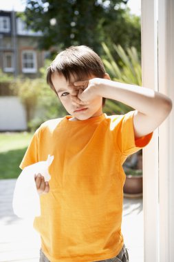 Boy rubbing eyes