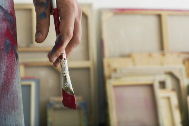 Artist holding paint brush  clipart