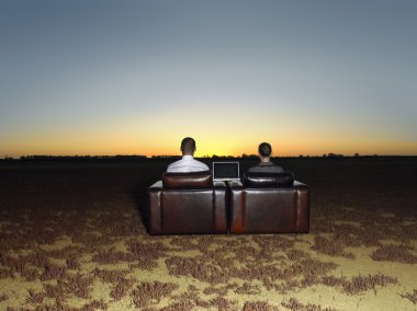 Business people in arm chairs at sunset clipart