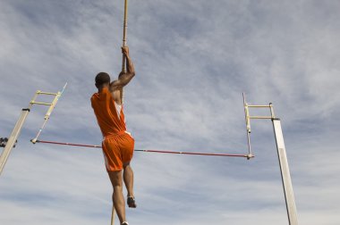 Athlete performing a pole vault clipart