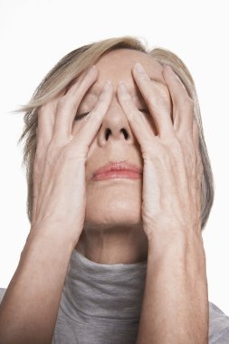 Senior woman with hands on face clipart