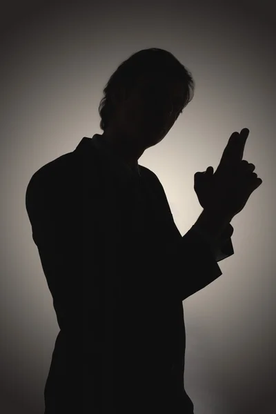 Shadow of man making gun-shaped gesture — Stock Photo, Image