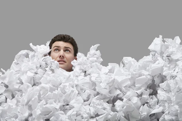 Man covered in crumpled paper — Stock Photo, Image