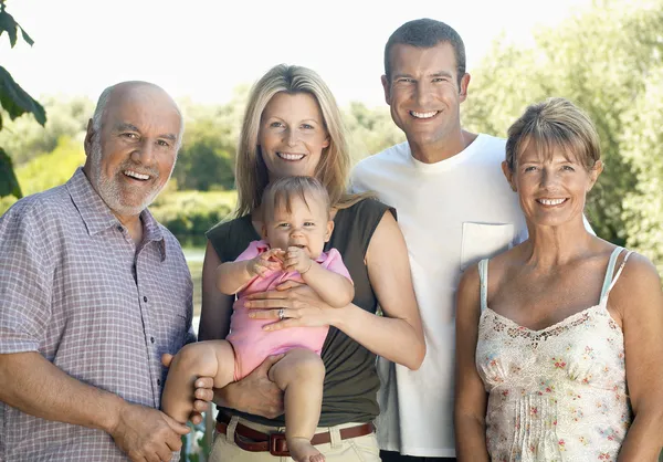 Baby girl with parents and grandparents — Stock Photo, Image