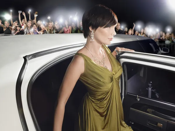 Woman getting out of limousine — Stock Photo, Image