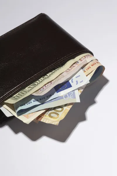 Wallet full of currencies — Stock Photo, Image