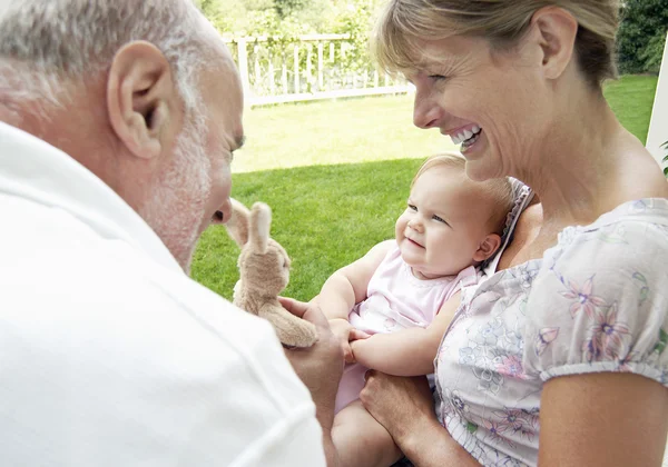 Grandparents playing with granddaughter — Stock Photo, Image