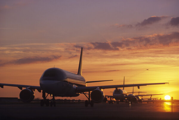 Planes Sitting on Tarmac at Sunset