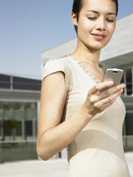 Mujer en plaza enviando mensaje de texto — Foto de Stock