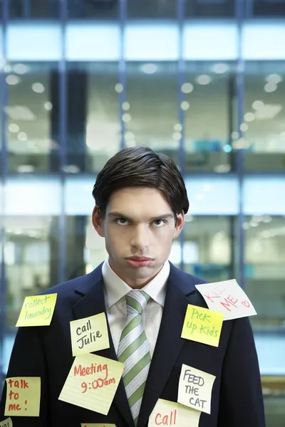 Businessman covered with Post-It notes — Stock Photo, Image