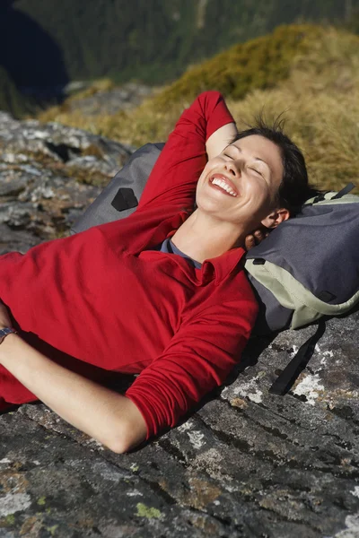 Woman laying on backpack — Stock Photo, Image