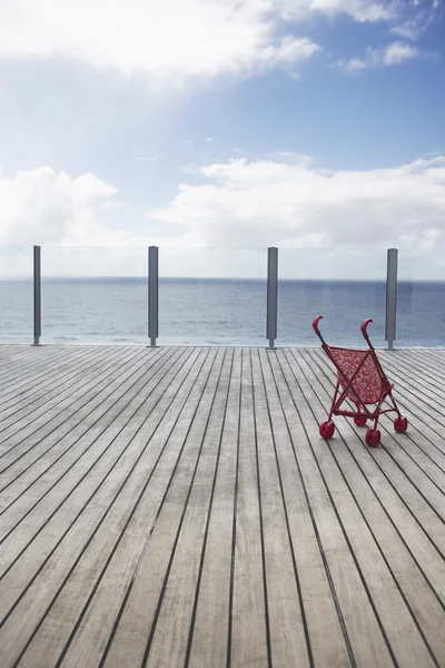 Baby stroller on wooden Dock — Stock Photo, Image