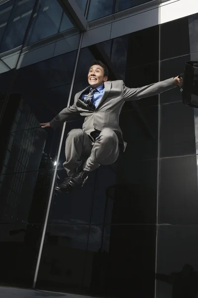 Businessman holding briefcase Jumping — Stock Photo, Image