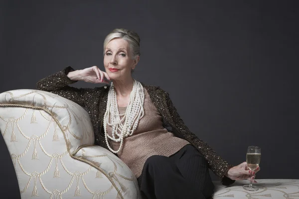 Elegant senior woman with champagne — Stock Photo, Image