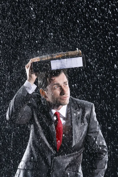 Businessman running through rain — Stock Photo, Image