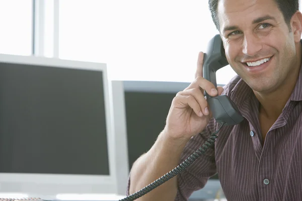 Businessman using landline phone — Stock Photo, Image