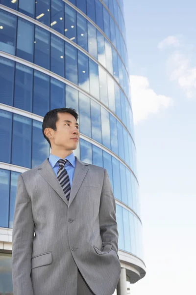 Businessman standing hands in pocket — Stock Photo, Image