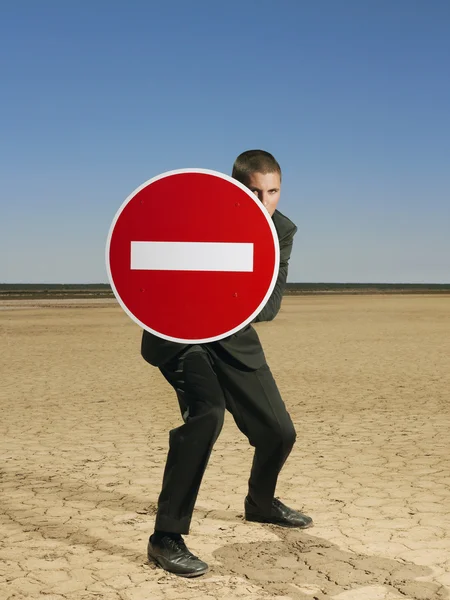 Businessman holding sign — Stock Photo, Image