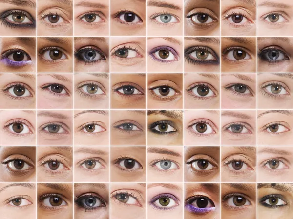 Olhos femininos na grade — Fotografia de Stock