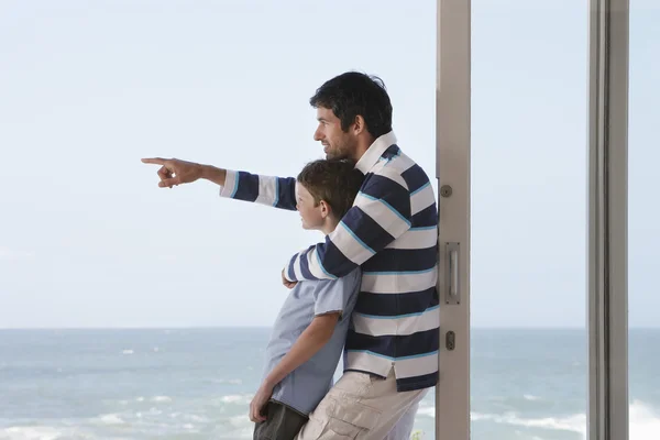 Vater zeigt aufs Meer — Stockfoto