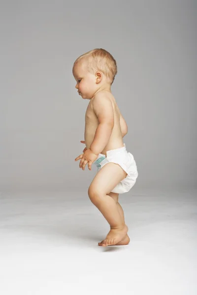 Cute baby taking first step — Stock Photo, Image