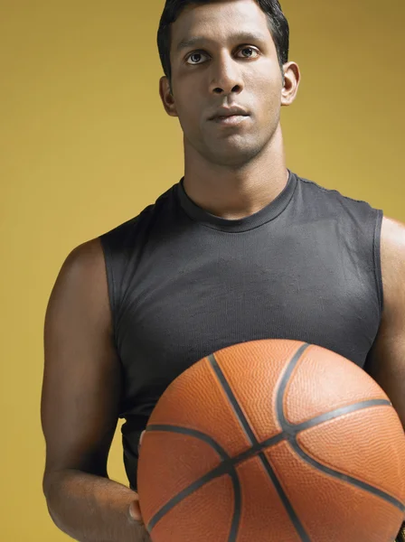 Athlete holding basketball — Stock Photo, Image