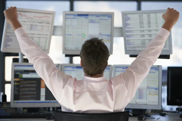 Businessman watching computer screens — Stock Photo, Image