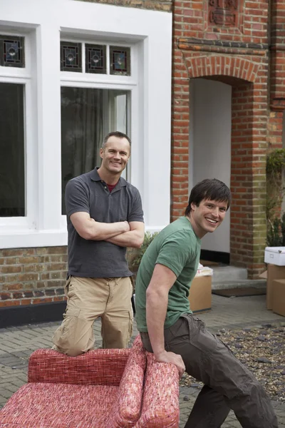 Two men with sofa — Stock Photo, Image