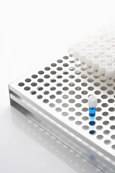 Blue test tube with empty test tubes — Stock Photo, Image