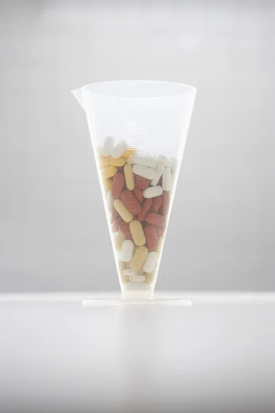 Pills in funnel — Stock Photo, Image