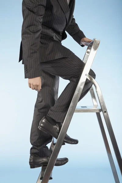 Geschäftsmann steigt Leiter hinauf — Stockfoto