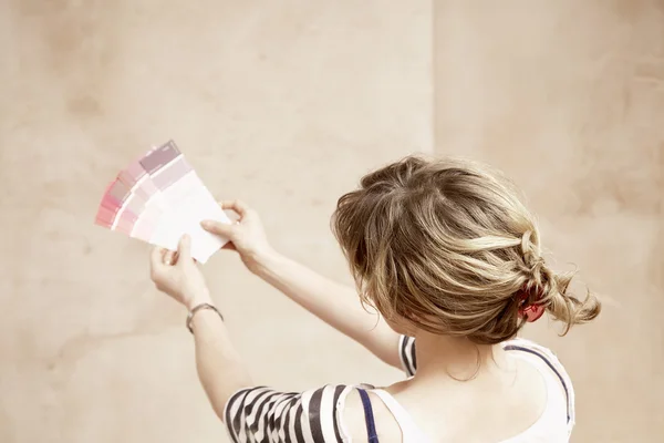 Vrouw kijken naar verf kleur stalen — Stockfoto