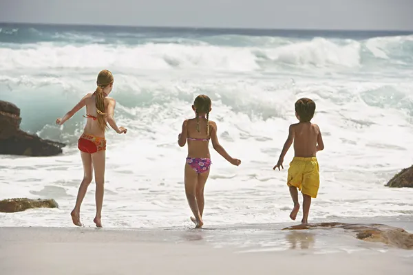 Niños alegres corriendo en el agua — Foto de Stock