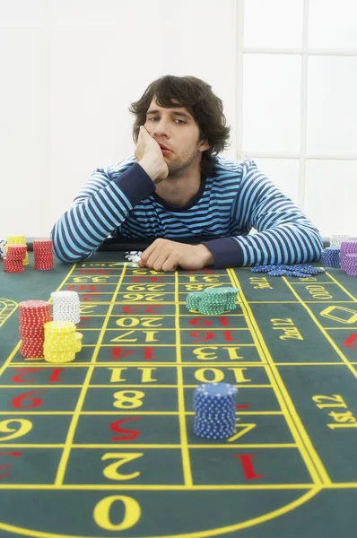 Homem frustrado à mesa da roleta — Fotografia de Stock