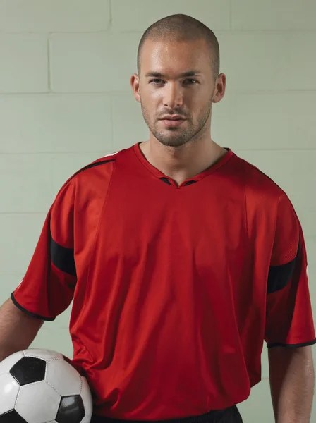 Soccer player holding ball — Stock Photo, Image