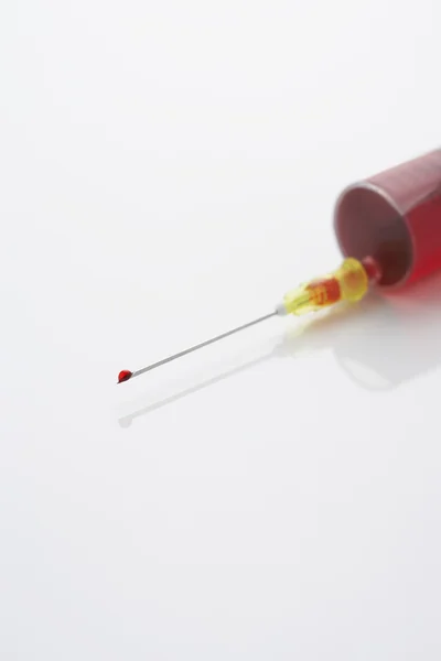 Syringe filled with blood — Stock Photo, Image