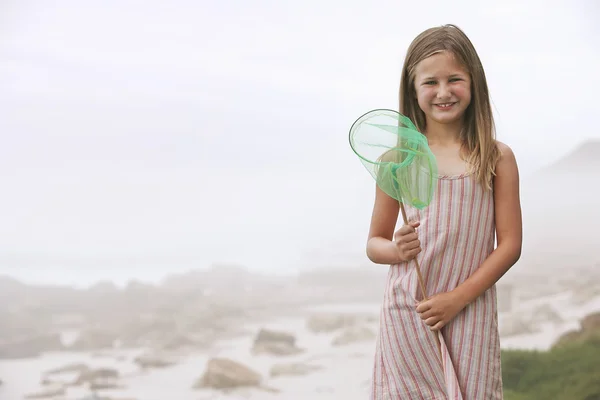 Girl holding fishing net — Stock Photo, Image