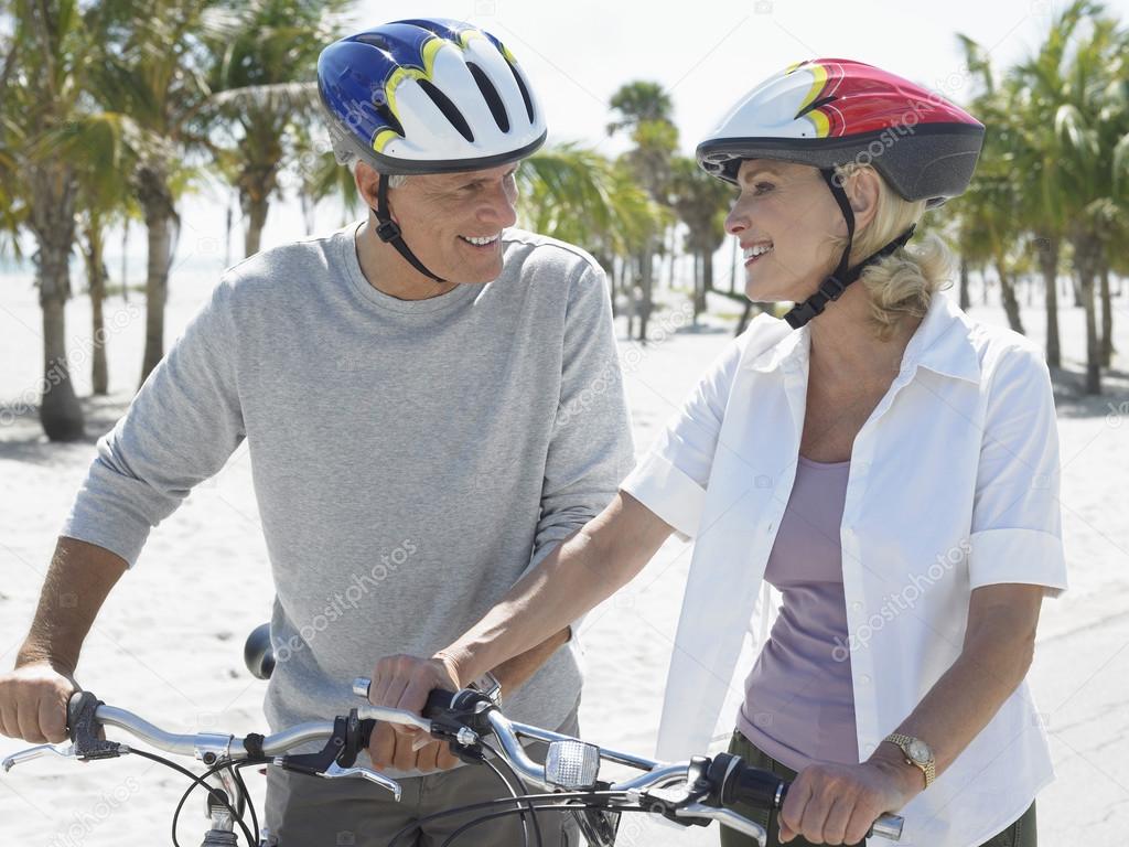 Couple with bicycles on tropical beach