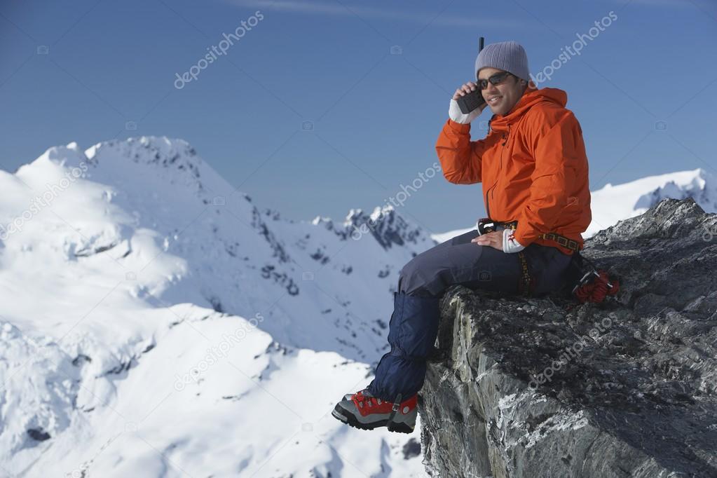 Mountain climber using walkie-talkie