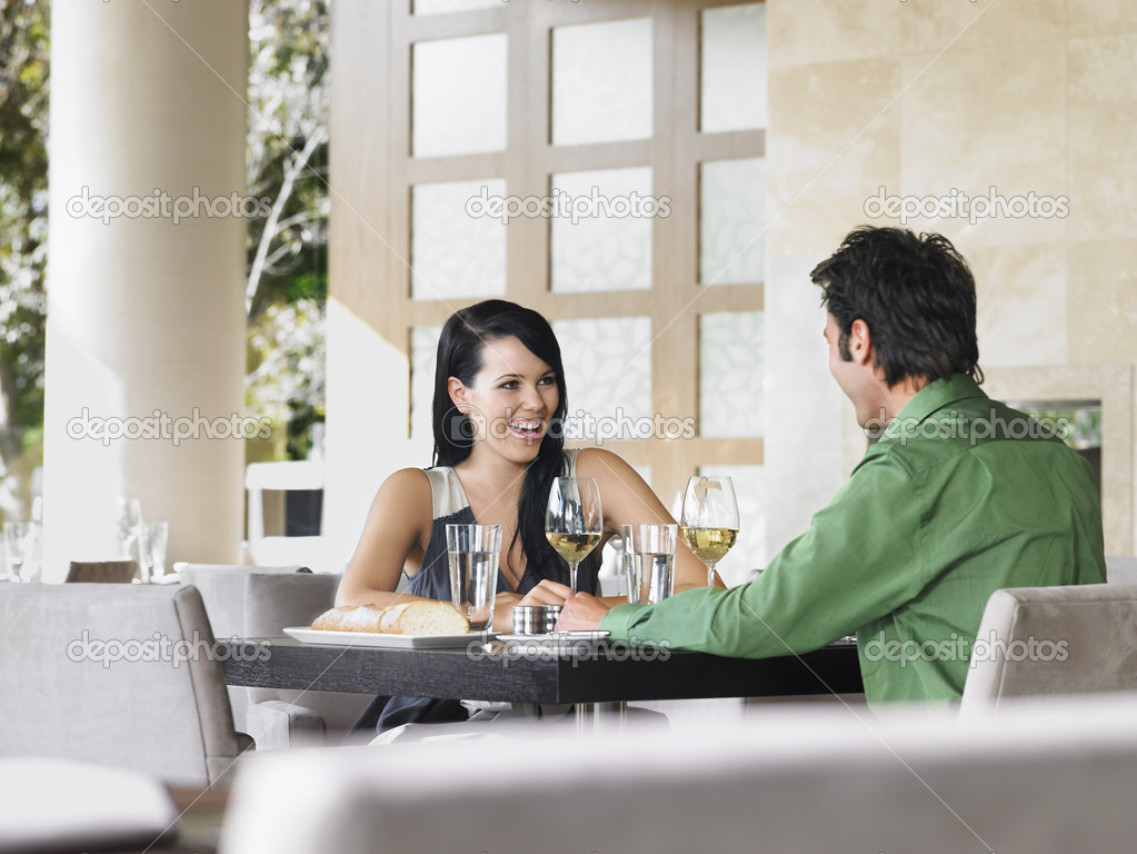 Couple laughing at restaurant