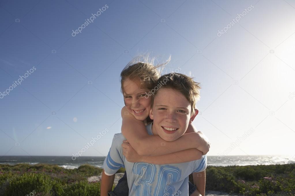 cheerful Boy piggybacking girl