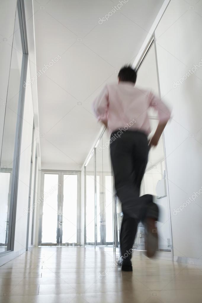 Businessman Running in Corridor