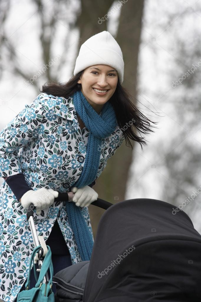 Mother walking with baby carriage