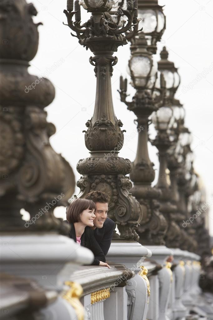 Couple looking over bridge