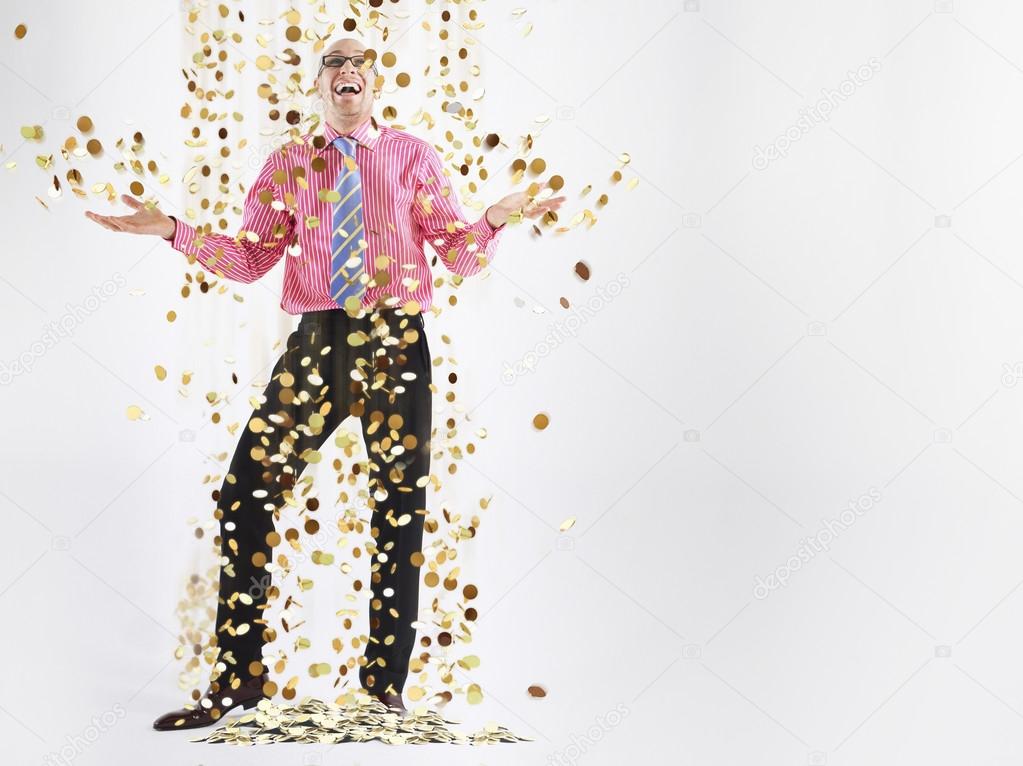 Man laughing with coins falling