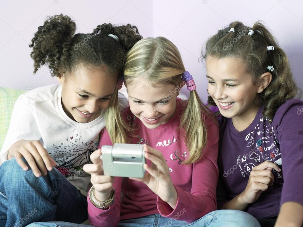 Girls playing with  gadget
