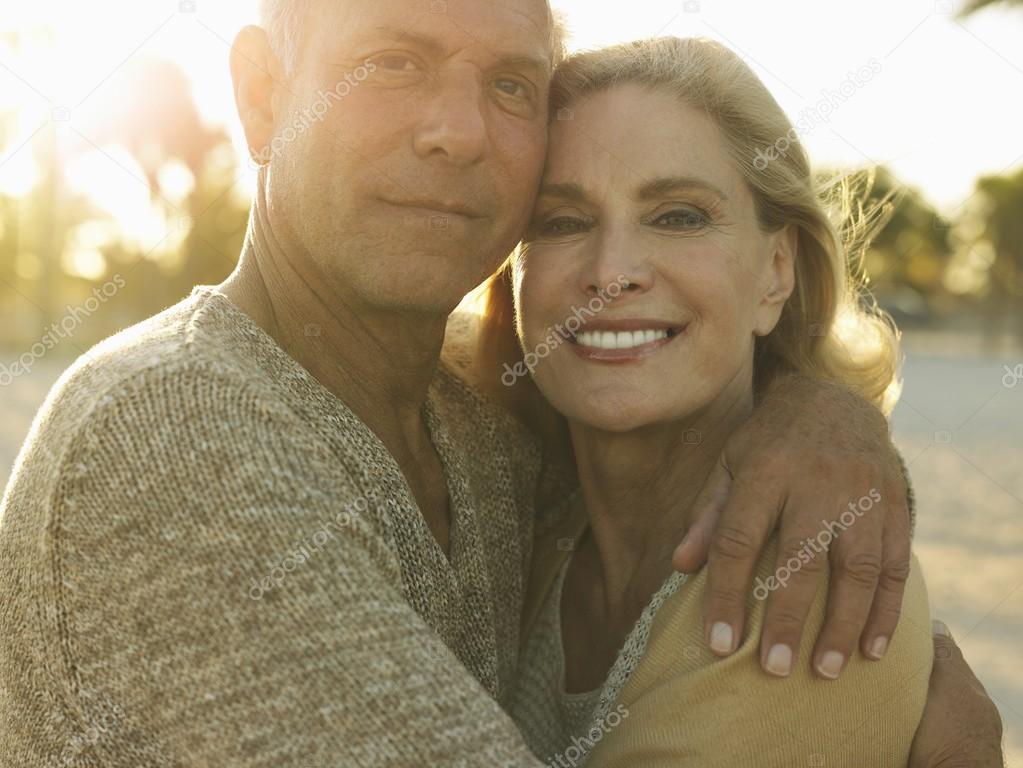 Senior couple embracing on tropical beach